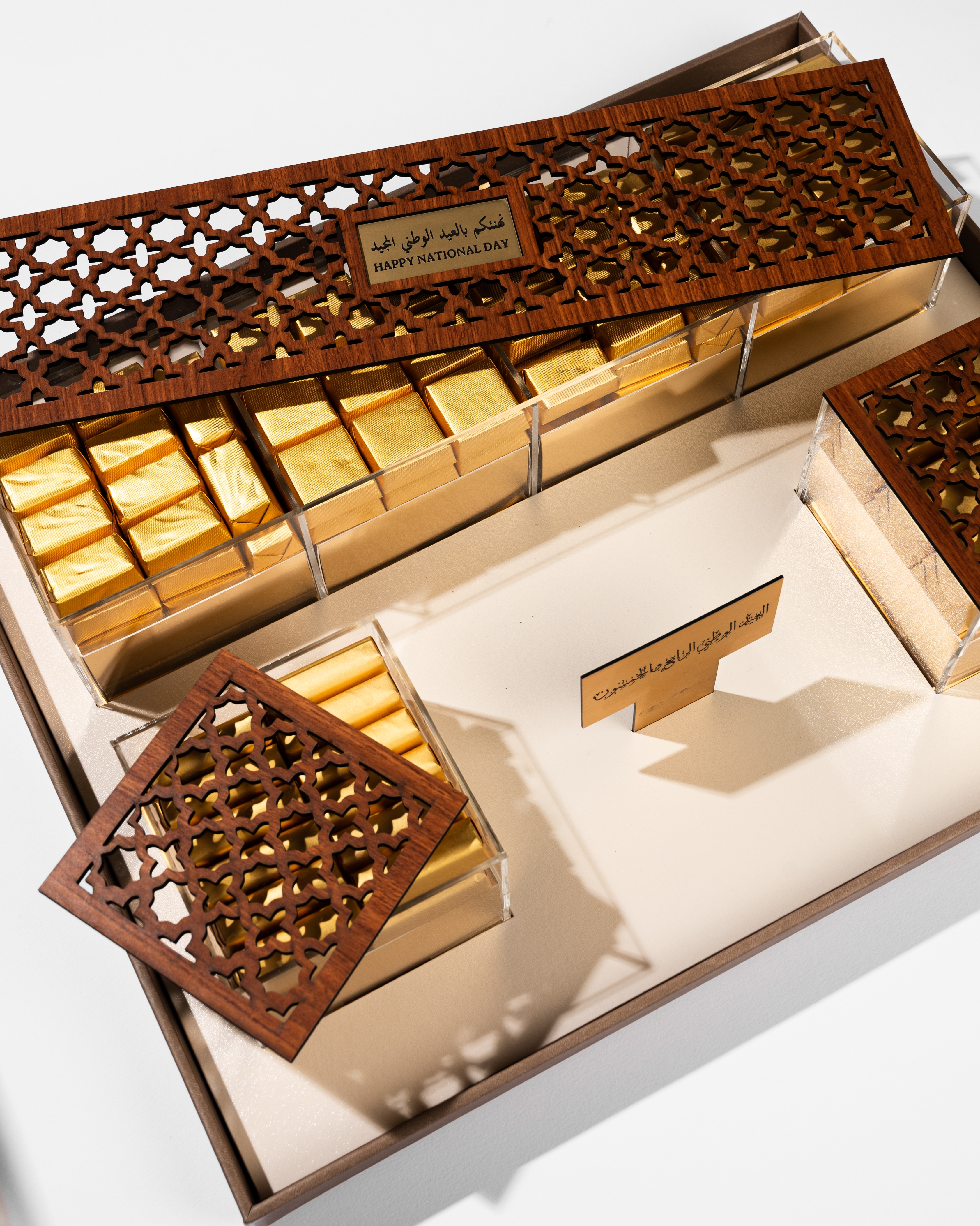 Ornate wooden lattice gift box with gold chocolates inside