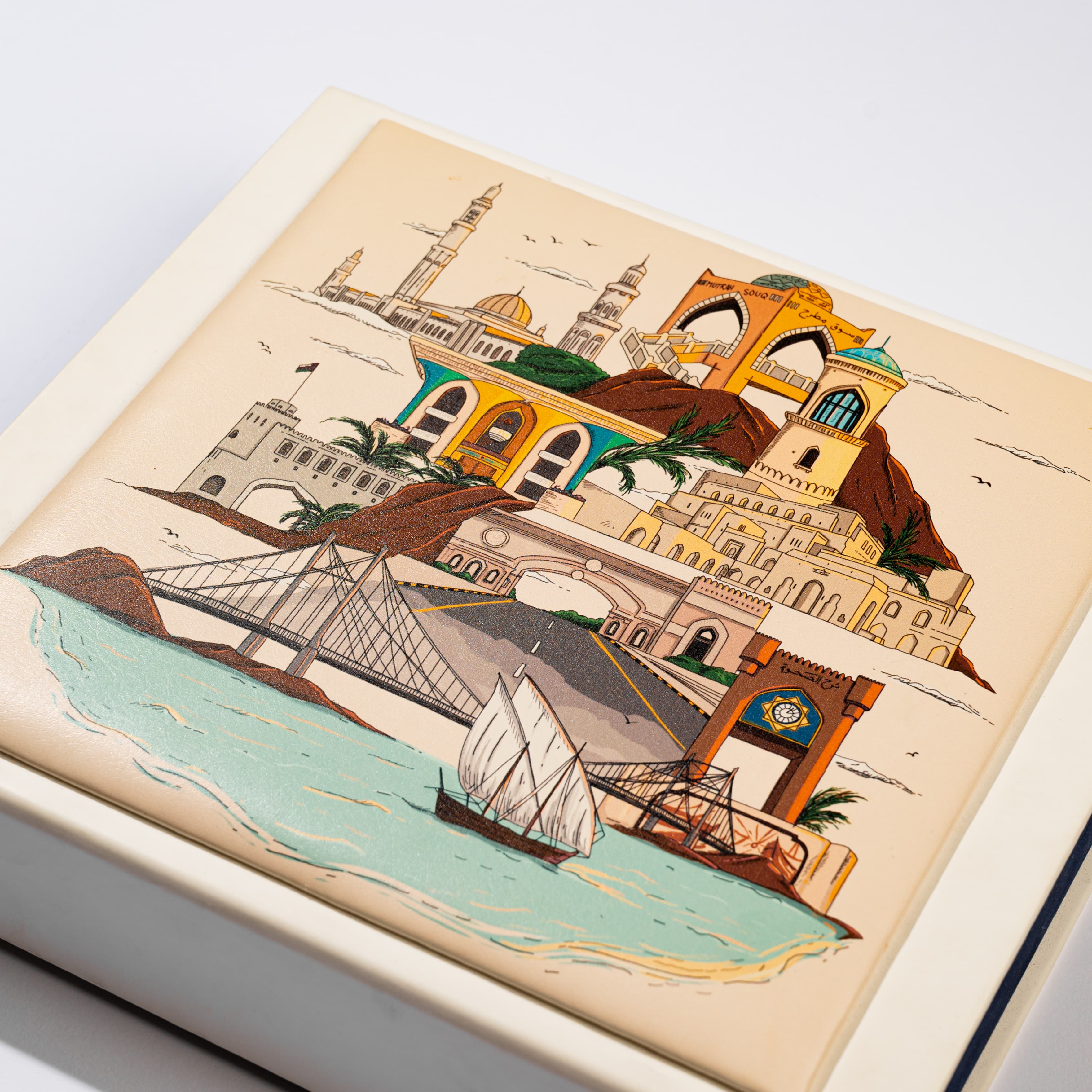 Gift box lid with a hand-illustrated Muscat cityscape